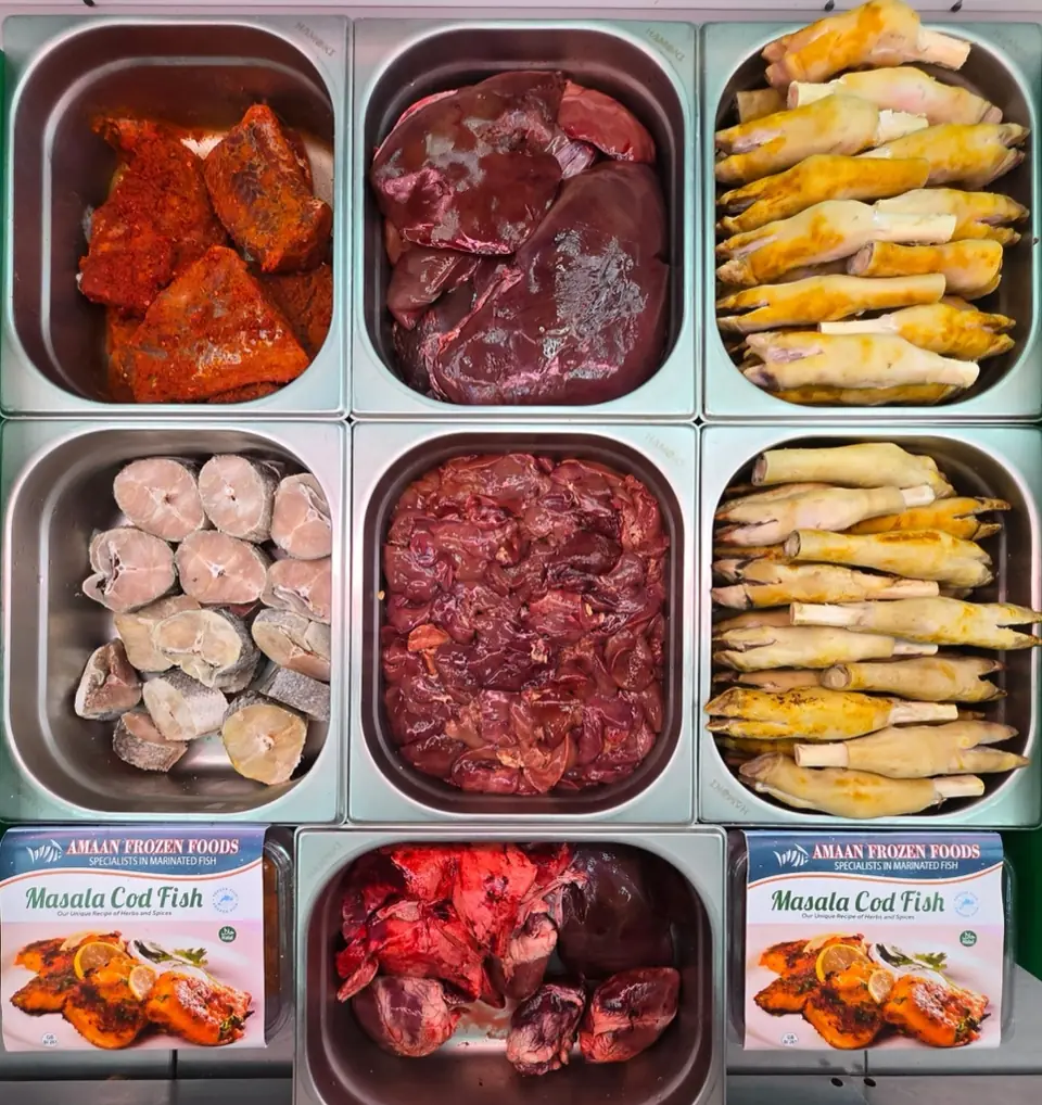 The counter from above: marinated pieces, liver, fish steaks, chicken feet and boxed masala cod