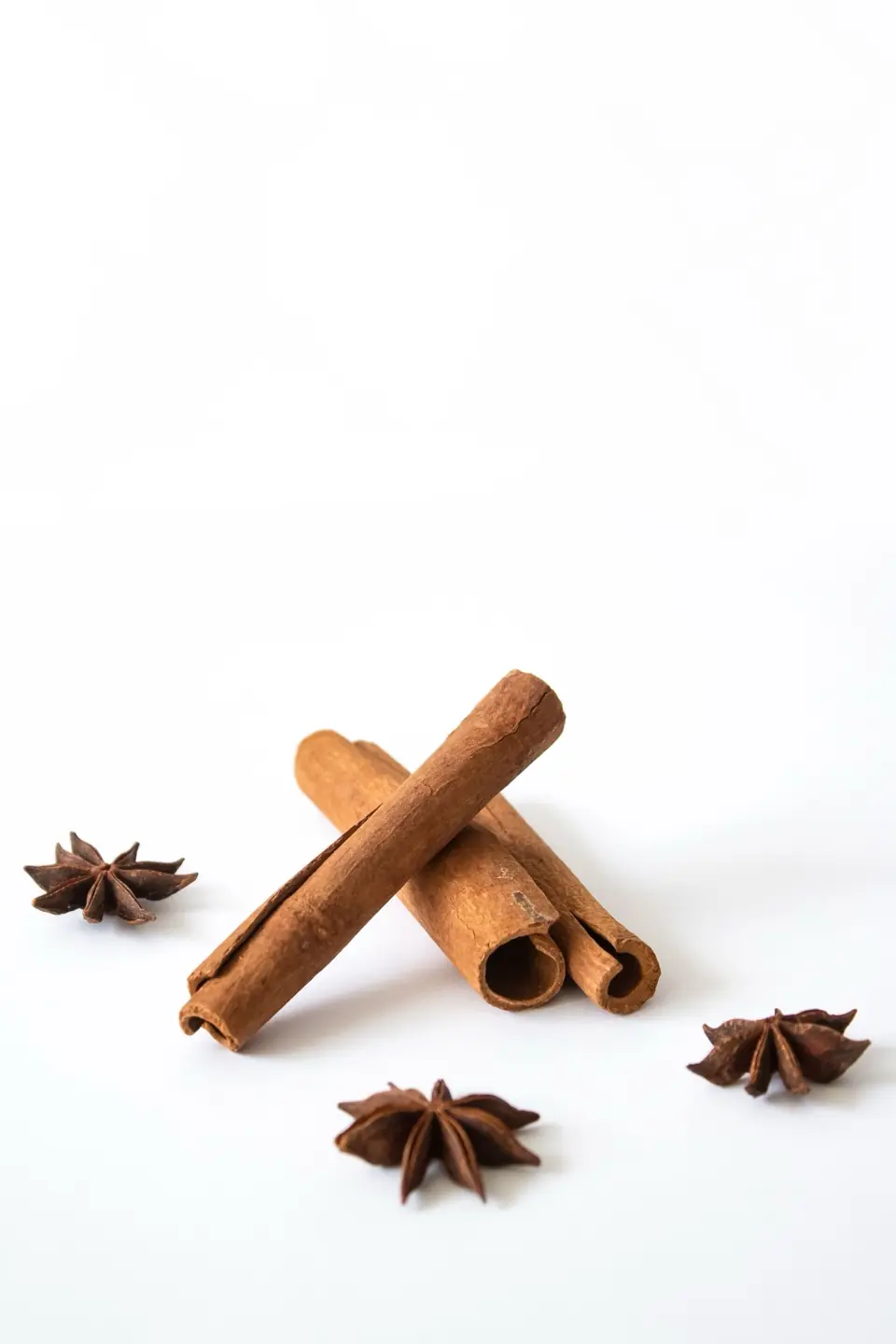 Cinnamon sticks and star anise on a white surface